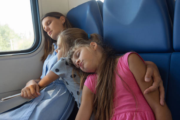 istock Asleep mom and daughters fell asleep in an electric train car 1184466749