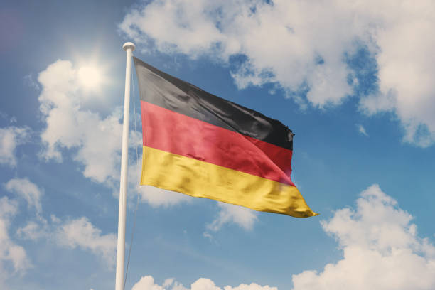 Flag of Germany, National symbol waving against cloudy, blue sky, sunny day National symbol waving against cloudy, blue sky, sunny day german flag photos stock pictures, royalty-free photos & images