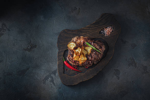 istock Roasted beef steak with parsnip chips, top lay copy space 1184471252