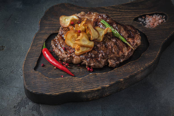 istock Beef chuck roll steak on wooden board, close view 1184471254