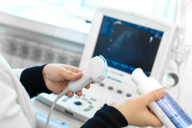 doctor prepare an ultrasound machine for the diagnosis of a patient. doctor puts media gel on an ultrasound transducer - ultrasound imagens e fotografias de stock