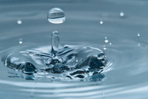 istock Beautiful splash of water drop on water surface, macro photo 1184472122