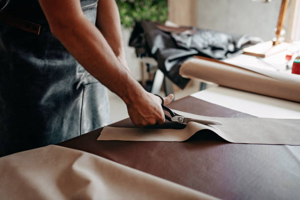 istock Tailor examining his new material for manufacture 1184472150