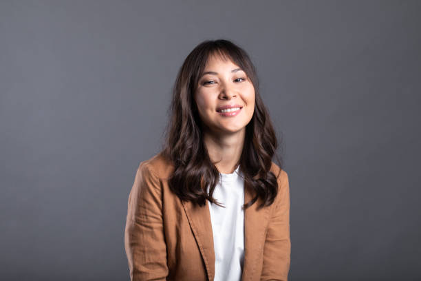 istock Young friendly asian woman with smiley face isolated. 1184473709