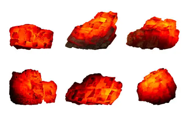 Different pieces of hot coal isolated on a white background close up. A group of burning coals of various shapes and temperatures. Raw coal mine nuggets on fire for power and fuel  industry