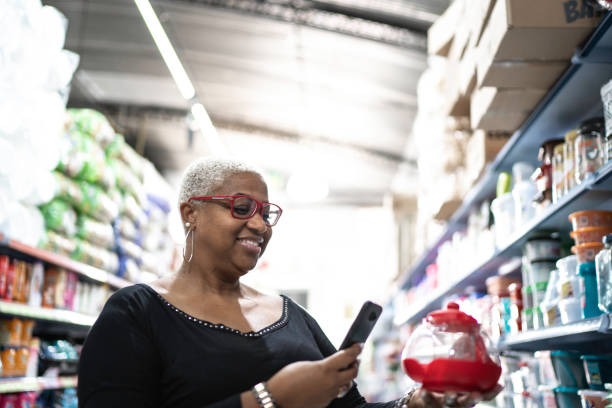 istock Customer seaching on the phone and holding a kettle at wholesale 1184479131