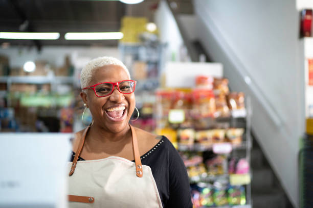 Happy cashier working at wholesale Happy cashier working at wholesale beautiful older black woman stock pictures, royalty-free photos & images