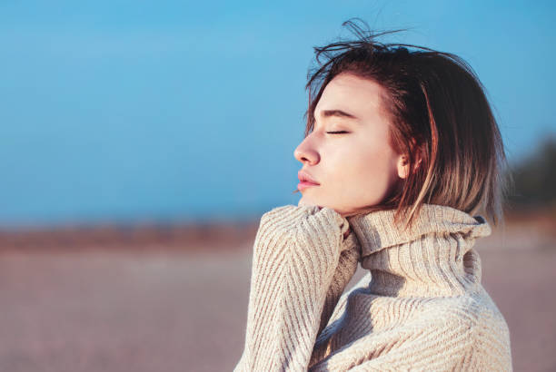 istock Happy woman in winter on a beach 1184480500