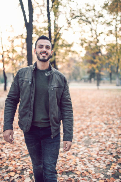 istock Handsome Male Talking A Walk In The Park 1184480592