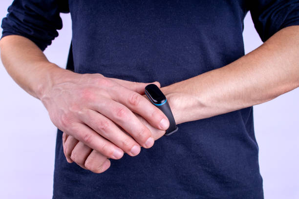 istock fitness tracker on person hands. wearing exercise gadget. 1184482049
