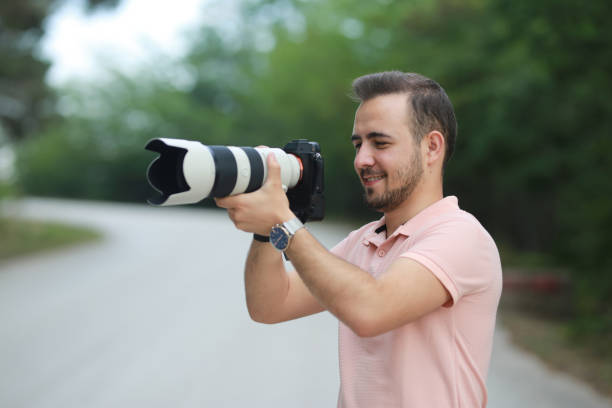 istock young photographer taking a photo on forest 1184483282