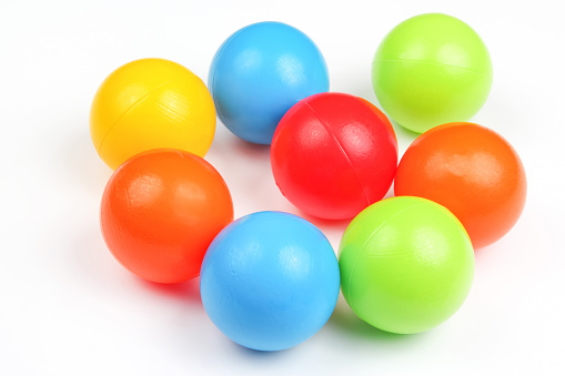 Colored plastic balls on white background