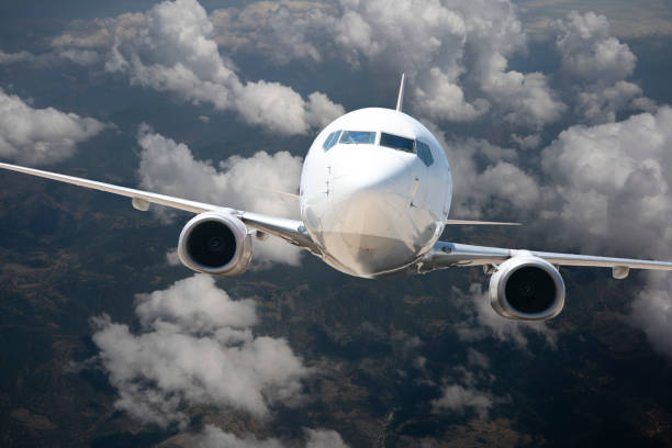 istock Commercial airplane flying above clouds 1184484447