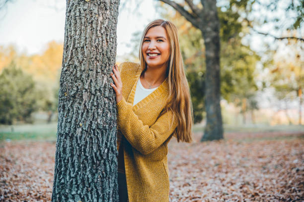 istock Young woman in autumn park 1184485405