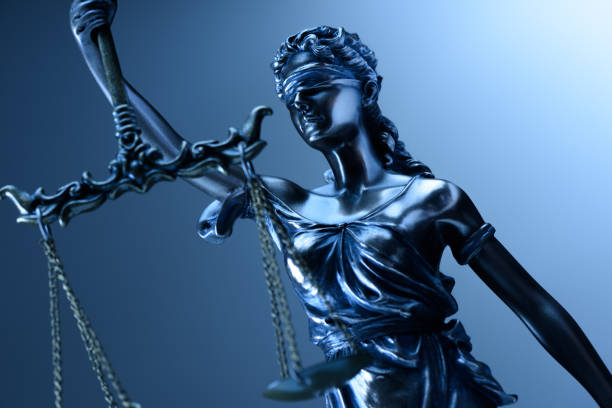 istock Statue of justice on blue background 1184488243