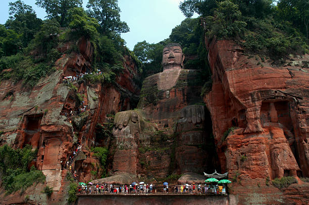 This statue of Buddha is 71 meters high and located near Leshan in the province Sichuan (western part of China). It's carved out of a cliff, overlooking the confluence of the rivers Min and Dadu. Work took place between 713 and 800 AC. From the top you can walk down to the feet and up agian to monastery and temples. MI#1723A.