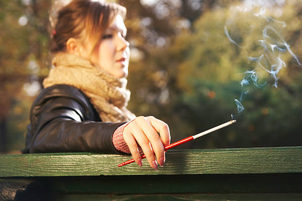 Woman smokes a mouthpiece stock photo