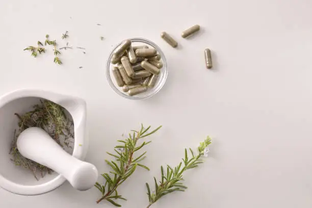 Photo of Mortar with medicinal herbs top alternative medicine