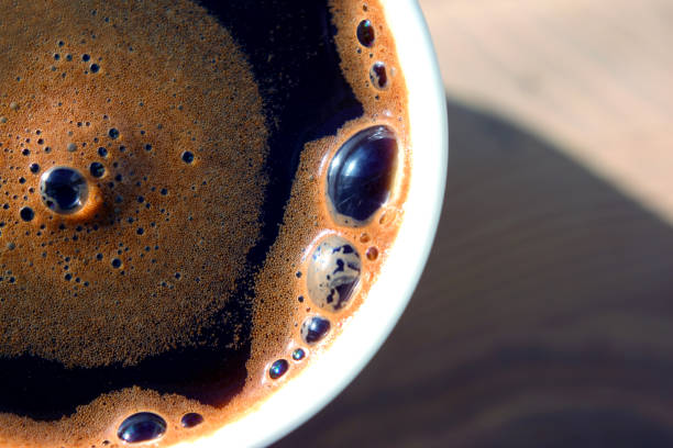 istock freshly brewed black coffee in a white cup in the sunlight. 1184495674