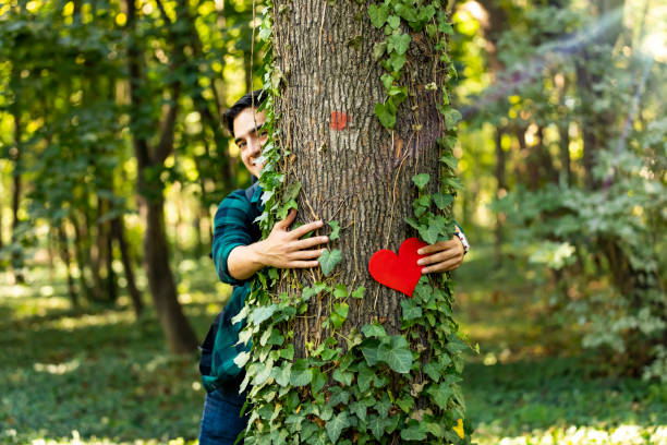istock Closeup hands of man hugging tree with heart shape, copy space. 1184496790