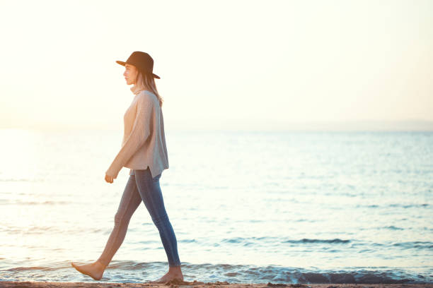istock Dreamy girl walking at beach during sunset 1184496903