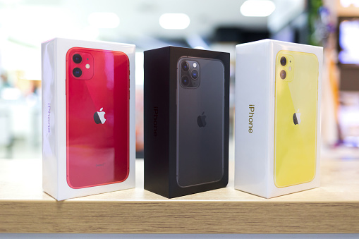Belgrade, Serbia - October 25, 2019: Three new Apple iPhone 11 and 11 Pro mobile cellphones are displayed in original cardboard boxes on isolated background. Close-up.
