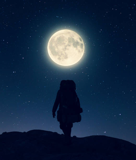 istock Backpacker on top of the peak under the moon light,3d illustration**3d figures 1184499704