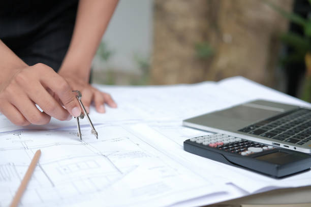 istock architect engineer working on house blueprint of real estate project. building construction concept 1184502212