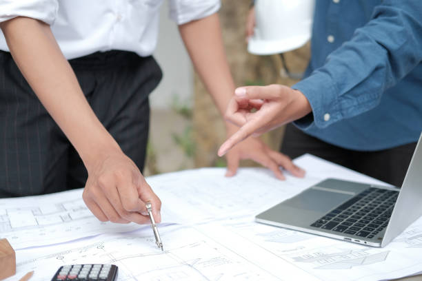 istock architect engineer working on house blueprint of real estate project. building construction concept 1184502222