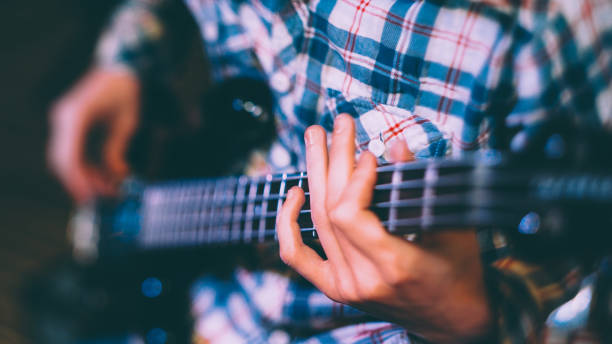istock music school guitar lesson male student instrument 1184502396