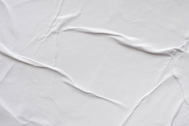 istock Blank white crumpled and creased paper poster texture background 1184502513