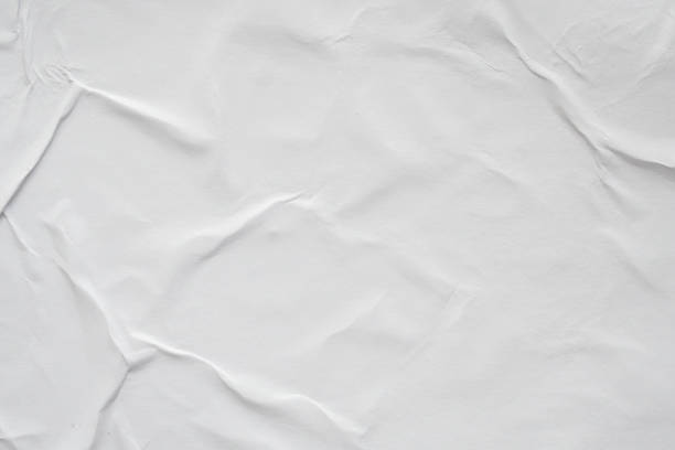 istock Blank white crumpled and creased paper poster texture background 1184502517