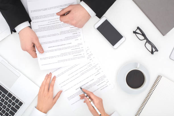 istock Two business people at office top view reading documents 1184502532