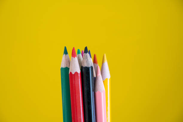istock Colorful drawing pencils on yellow background 1184502911