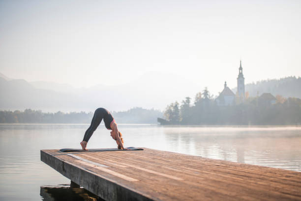 istock Downward Facing Dog Position on Pier Overlooking Lake Bled 1184503075