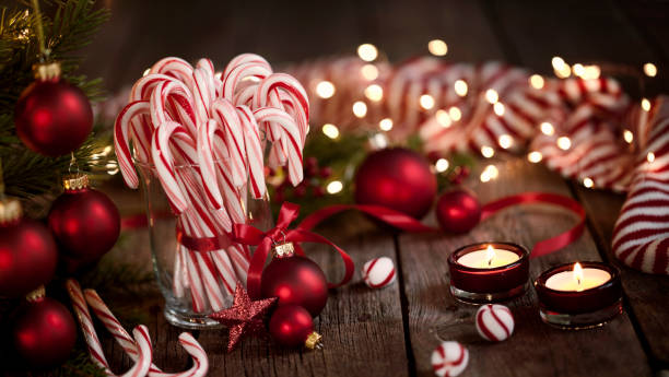 istock Candy Canes and Bright Christmas Lights on an Old Wood Background 1184503290