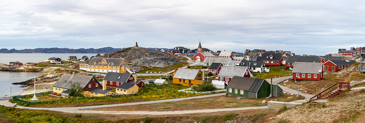 Panoramic view of colorful houses with the school Det gamle Sygehus, the cathedral and the statue of Hans Egede in the background, Nuuk, Greenland.