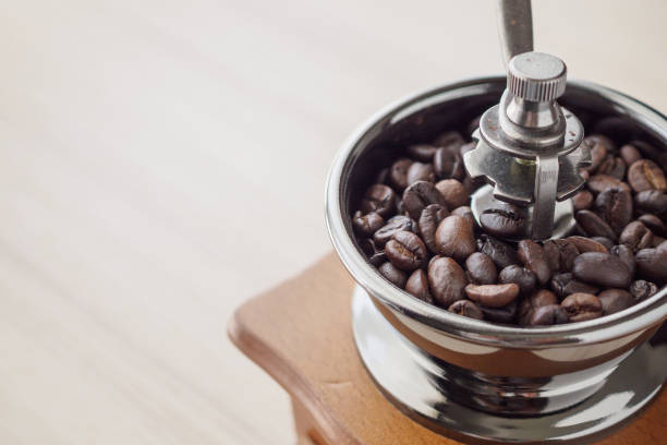 istock Vintage manual coffee grinder with roasted coffee beans 1184506490