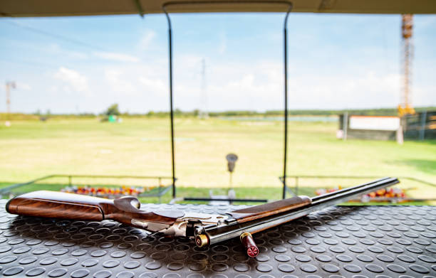 Shotgun on Table on Shooting Range Outdoors Shotgun on Table on Shooting Range Outdoors. trap shooting stock pictures, royalty-free photos & images