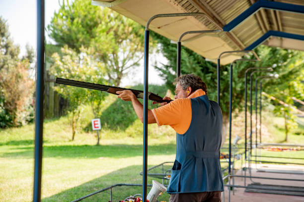 istock Mature Man Practicing Skeet Shooting With Shotgun While Standing on Firing Lane 1184506562