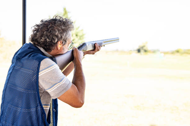 istock Mature Man Aiming With Shotgun Outdoors 1184506591