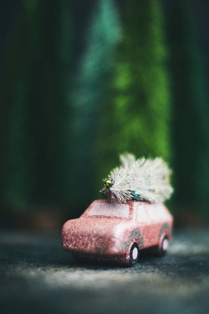 istock Pink car transporting Christmas tree. Christmas holiday background. 1184506845