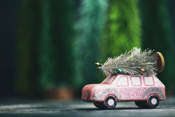 Pink car transporting Christmas tree. Christmas holiday background. Pink car transporting Christmas tree. Christmas holiday background. pink christmas tree stock pictures, royalty-free photos & images