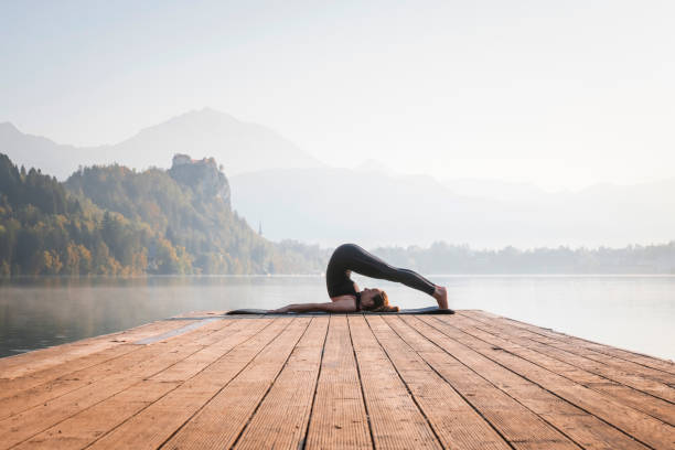 istock Yoga Plow Pose on Pier Overlooking Lake Bled 1184507513