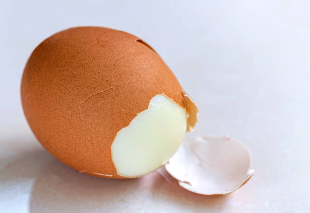 istock The boiled egg is broken and peeled on the table in the kitchen. 1184508407