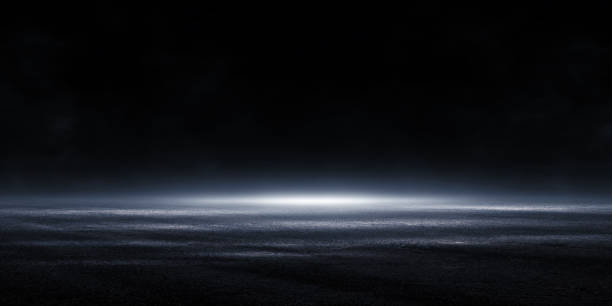 istock 3D rendering Abstract asphalt light in a dark empty street with smoke, Dark background scene of empty street night city. 1184508674