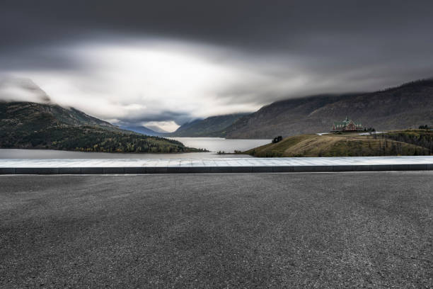 istock Empty road by Waterton Lake with storm clouds overhead 1184510009