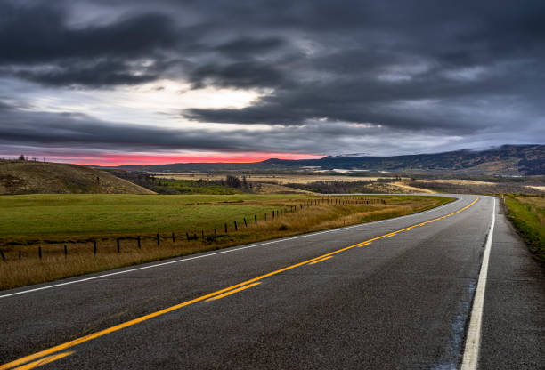 Winding highway against storm clouds,Alberta, Canada.
