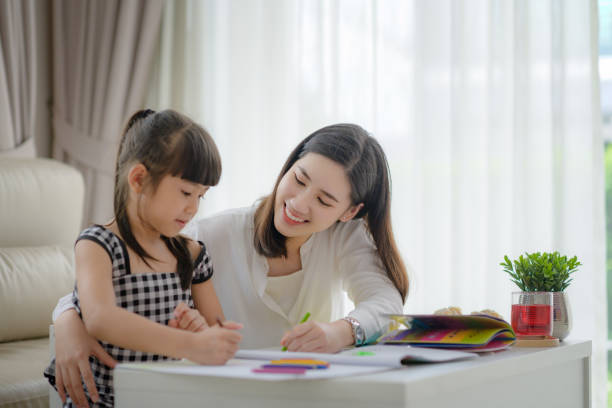 Family 51 modern mother joining homework together with daughter, happy time in living home and comfortable feel free asian kids learning stock pictures, royalty-free photos & images