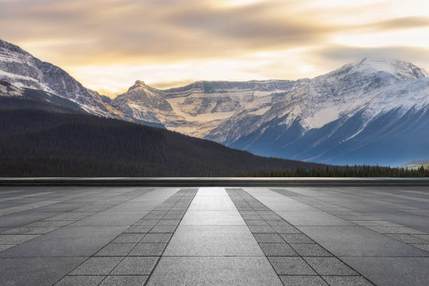istock Sunset view of snowy mountains with empty patio on foreground 1184512160